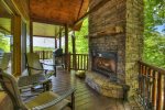 Main floor porch with a wood burning fireplace 